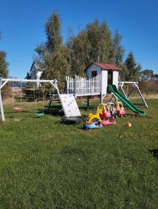 a group of childrens playground equipment in a field at Pod starą chatą 2 in Wicie