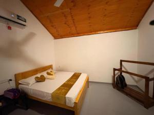 a bedroom with a bed with two towels on it at Econest arugambay in Arugam Bay