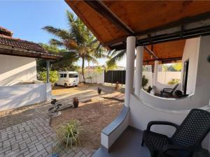 a house with a patio with a table and chairs at Econest arugambay in Arugam Bay