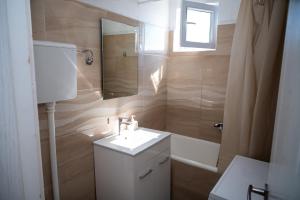 a bathroom with a sink and a mirror and a tub at Apartment Jasovic in Ulcinj +40 photos