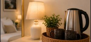 a lamp and a bottle of milk and a plant on a table at Knossos Breeze in Sitia