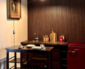 a kitchen with a sink and a table with dishes at Villa Del Mar in Jūrmala