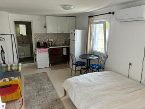 a kitchen with a bed and a table in a room at Small House in Bodrum in Milas +25 photos