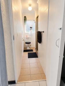 a hallway leading to a bathroom with a toilet at Zhantique Guest House 2- Unit 4 in Boksburg