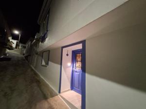 a blue door on the side of a building at Oikos Filon in Palaiókastron +26 photos
