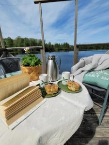 a table with two plates of food on a boat at Linnåsen stuga in Rottneros