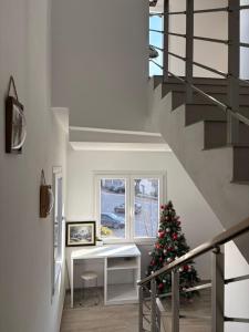 a staircase with a christmas tree in a house at Hotel SKURA , Librazhd in Librazhd