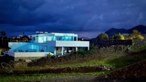 a house on top of a hill at night at Casa Calma in Las Breñas