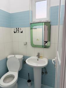 a bathroom with a toilet and a sink at Apartments Gigu in Ksamil