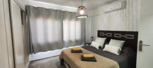 a bedroom with a bed with two pillows on it at El Bungalow in Playa Fañabe +59 photos