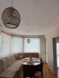 a living room with a couch and a table at Къща за гости Шишкови in Shabla