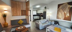 a living room with a couch and a table at El Bungalow in Playa Fañabe