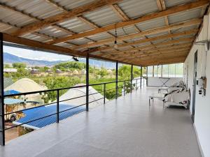 a large room with a balcony with a view at Guesthouse Snow Leopard - 'Ak Ilbirs' in Tong