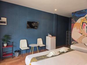 a bedroom with a bed and a tv on a wall at Near the Beach Cha-Am in Cha Am