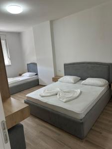 a bedroom with a bed with two pillows on it at Sea flavor 2 in Shëngjin