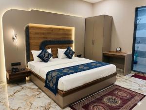 a bedroom with a large bed in a room at Hotel Grand Heaven in Tājganj