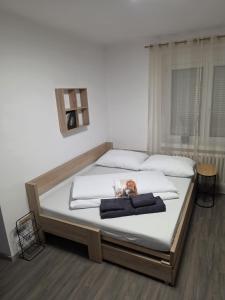 a bedroom with a bed with a dog on it at Apartmán Jonas - Riegrova 41 in Děčín