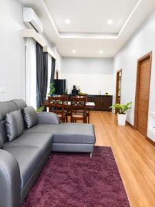 a living room with a couch and a table at Villa Escape Aonang Krabi in Krabi