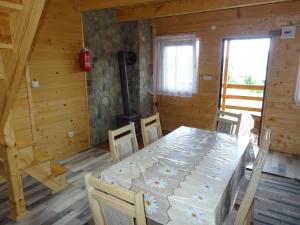 a dining room with a table and chairs at Domek Bieszczady Wolkowyja 2 nad Solina in Wołkowyja