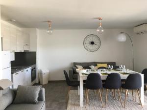 a kitchen and a dining room with a table and chairs at Porto-Vecchio 2-bedroom apartment, pool in Porto-Vecchio