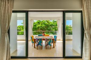 a dining room with a table and chairs at Sandbox Apartment 4 Diani Beach Kenya in Ukunda
