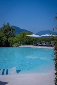 a large swimming pool with chairs at Collina d'Oro Resort & SPA in Lugano