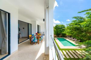a view from the balcony of a house with a swimming pool at Sandbox Apartment 4 Diani Beach Kenya in Ukunda