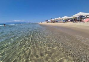a beach with a group of umbrellas and the ocean at Matenia’s house in Mángana