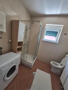 a bathroom with a shower sink and a toilet at AP apartment in Mostar