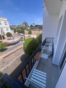 a balcony of a building with benches and the ocean at Beachfront Studio in Castillo de la Duquesa in Castillo de Sabinillas +12 photos