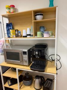 a microwave and a coffee maker on a shelf at Klein aber fein in Meiningen in Meiningen