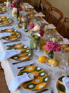 a table with plates of food and flowers on it at Riant Relais de Charme in Greve in Chianti