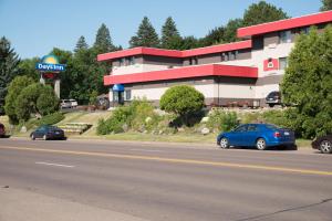 a blue car is parked in front of a building at Days Inn by Wyndham Duluth Lakewalk in Duluth