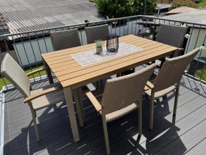 a wooden table and chairs on a deck at Gästehaus Brigitte Duri in Rust