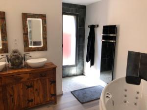 a bathroom with a tub and a toilet and a sink at L'éphémère-Private Spa in Plérin