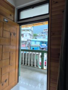 a door leading into a room with a window at Zen Homestay in Dirang Dzong