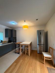 a kitchen with a table and a stainless steel refrigerator at Tapada De Sao Domingos in Gondomar