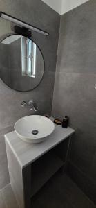 a bathroom with a white sink and a mirror at Aggeliko Seaside in Gythio +22 photos
