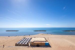 a beach with a bunch of barrels on it at Magnifique appartement avec vue mer panoramique ! in Valras-Plage