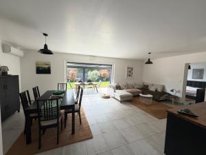 a living room with a table and a couch at Maison Eguilles in Éguilles +3 photos