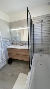 a bathroom with a tub and a sink and a shower at Maison Eguilles in Éguilles