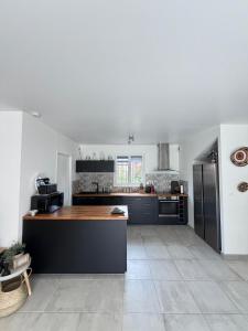 a kitchen with a wooden counter top in a room at Maison Eguilles in Éguilles