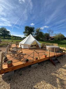 a white tent sitting on top of a wooden deck at Hupkac Glamping retreat in Vodranci