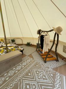 a statue of a person in a room with a floor at Hupkac Glamping retreat in Vodranci