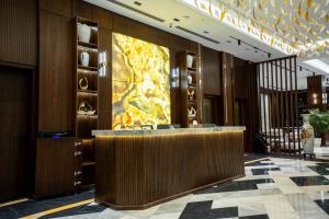 a lobby of a hotel with a reception desk at Grand Babl in Erbil