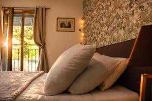 a bedroom with a bed with two pillows on it at La Bergerie de Losse in Traize +6 photos