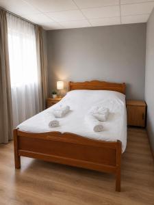 a bedroom with a bed with white sheets and pillows at Bluebell Cottage in Tsalka