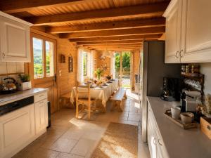 a kitchen with a table and a dining room at Charming family Chalet for 8 people, with private Hot Tub in Les Clefs