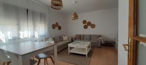 a living room with a couch and a table at Casa rural El Yelmo in Miguel Esteban