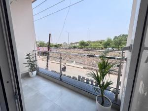 a balcony with plants and a view of a train track at Hotel Stayvilla Raipur in Raipur +9 photos